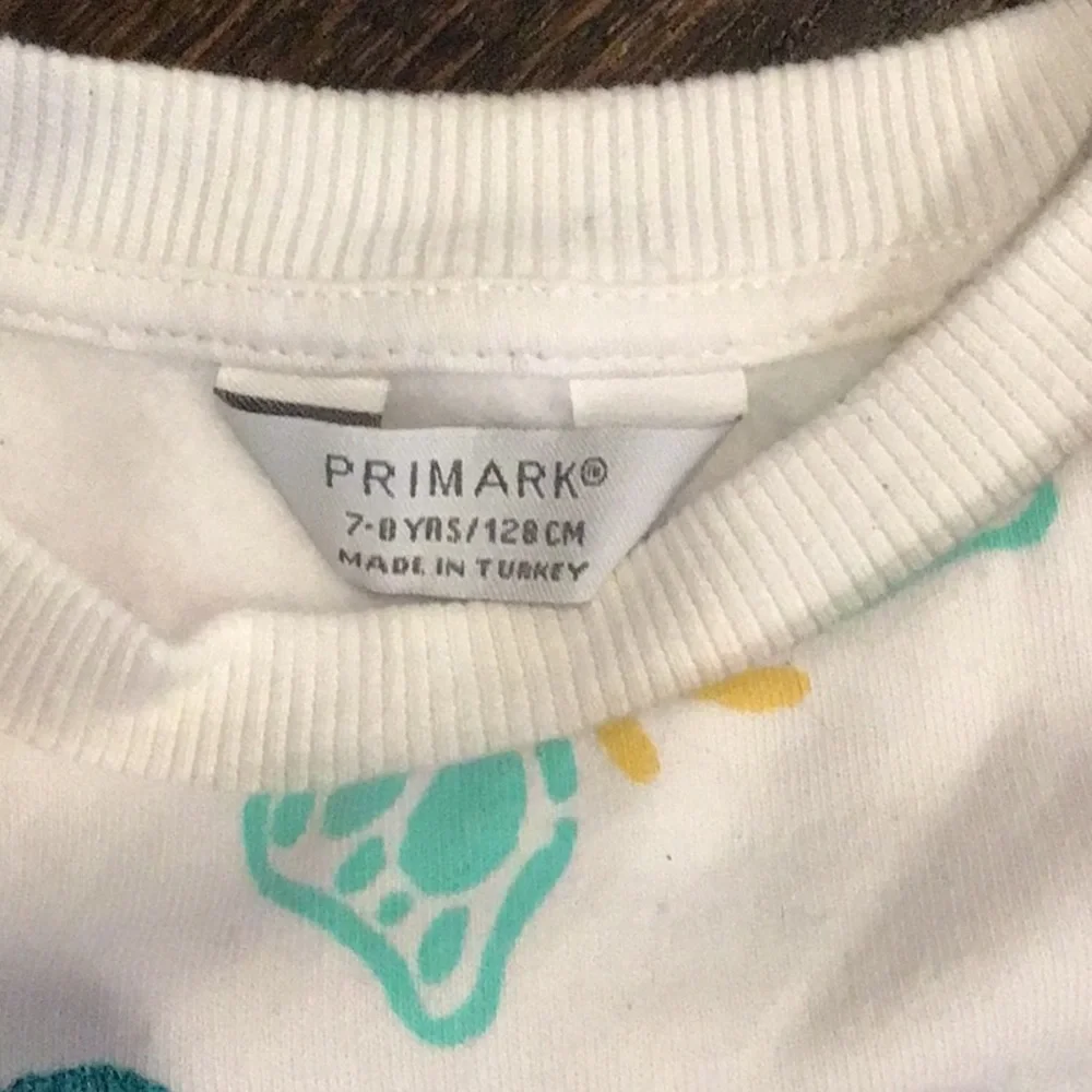 PRIMARK -children's tracksuit featuring a colorful all-over graffiti-style print